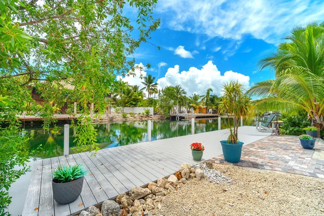 a view of a terrace with a garden and trees