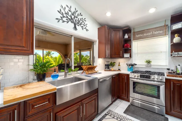 a kitchen with a sink stove and cabinets