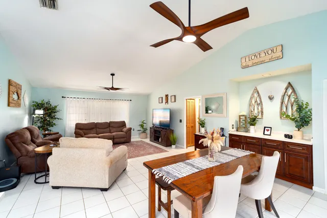 a living room with fireplace furniture and a large window