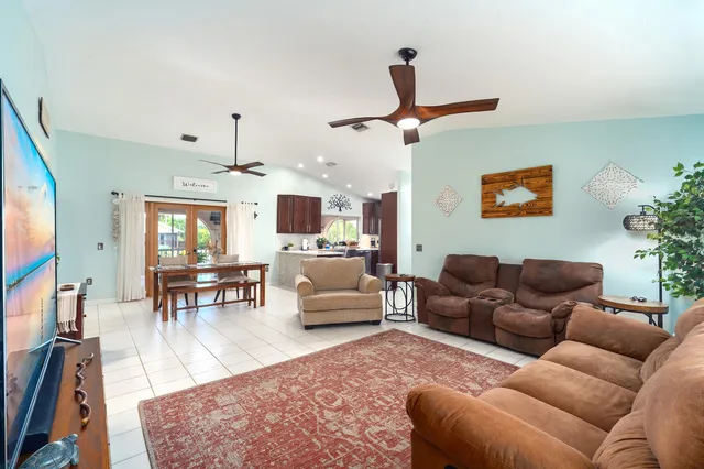a living room with furniture ceiling fan and a rug