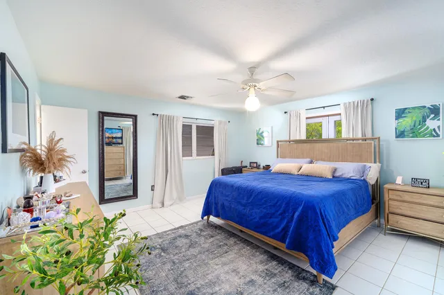a bedroom with a bed and a potted plant