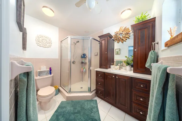 a spacious bathroom with a granite countertop sink toilet and shower