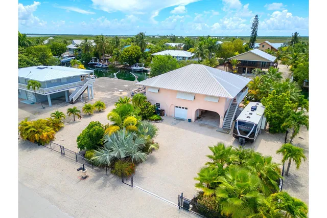 an aerial view of a house with yard and outdoor seating
