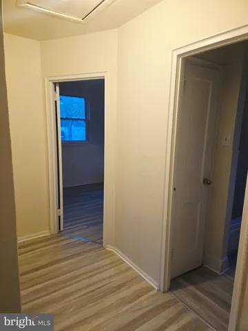 a view of hallway with wooden floor