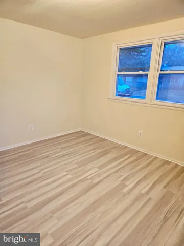 a view of a room with wooden floor and cabinet