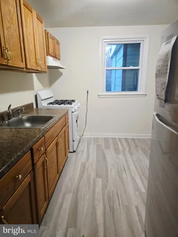 a kitchen with wooden cabinets and a sink