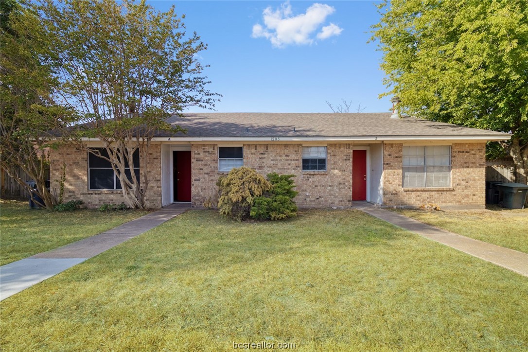 a view of a house with a yard and garage