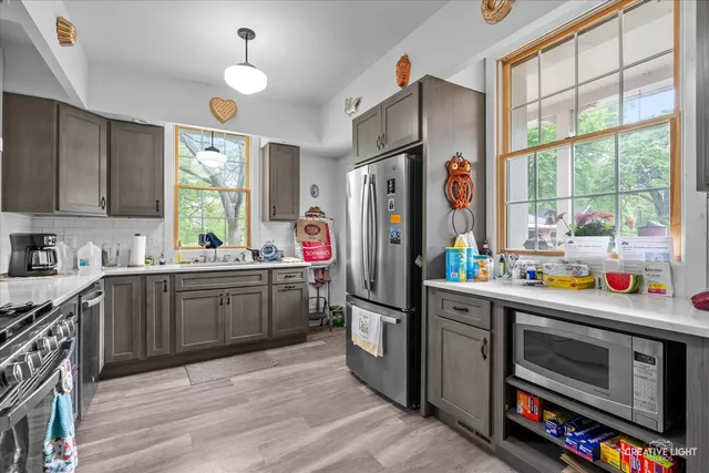 a kitchen with stainless steel appliances a stove a refrigerator and a sink