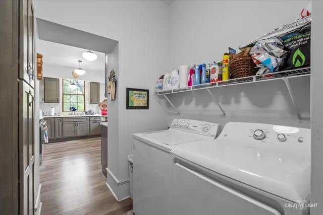 a utility room with dryer washer and sink