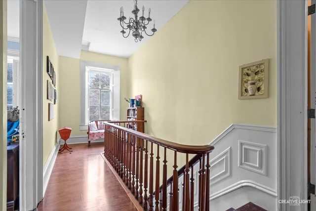 a view of a hallway to a livingroom with furniture