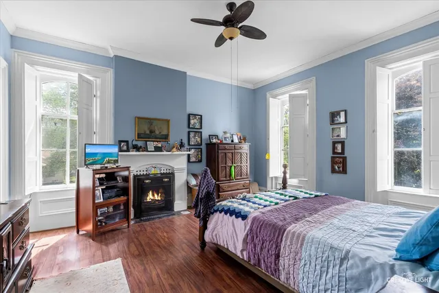a bedroom with a bed and a flat tv screen on the dresser