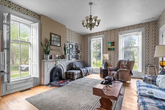 a living room with furniture large window and a table