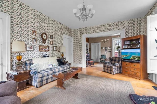 a living room with furniture and a chandelier