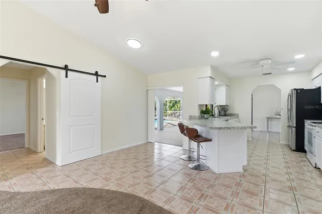 a view of kitchen with refrigerator and table