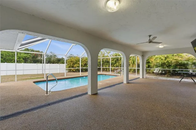 a view of an empty room with wooden floor and windows