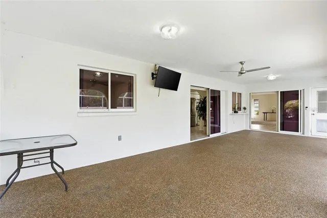 a view of an empty room with window and cabinet