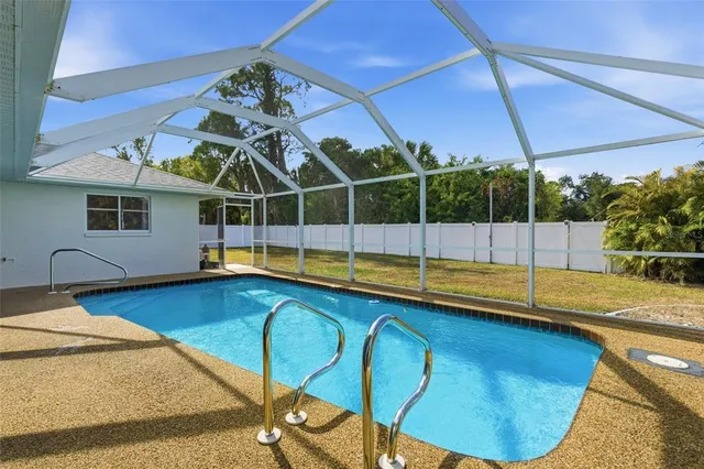 a view of a backyard with swimming pool