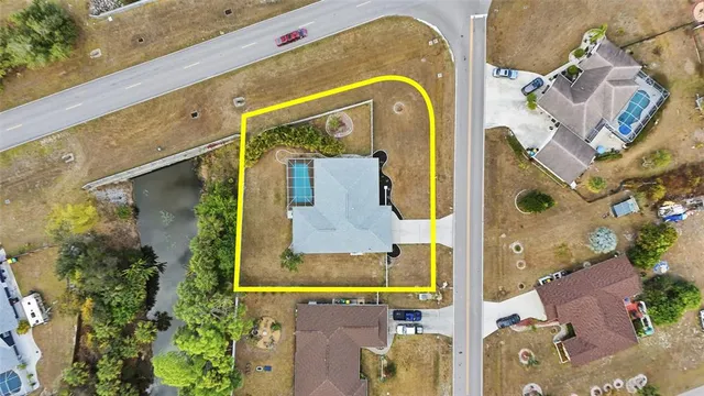 an aerial view of residential house with outdoor space and swimming pool