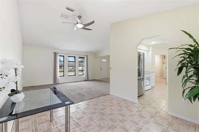 a view of a livingroom with furniture and chandelier fan
