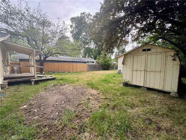a backyard of a house with table and chairs
