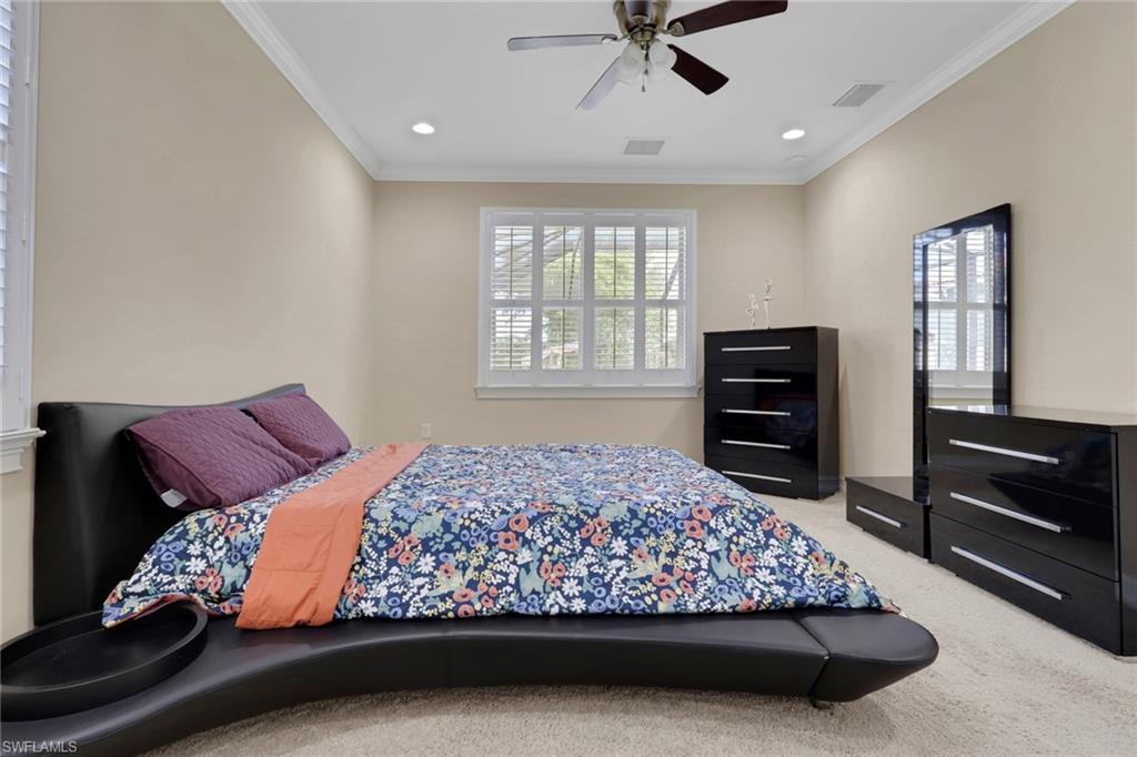 16309 Aberdeen Way Naples, FL 34110 - Photo 15 of 34 a bed sitting in a bedroom next to a window