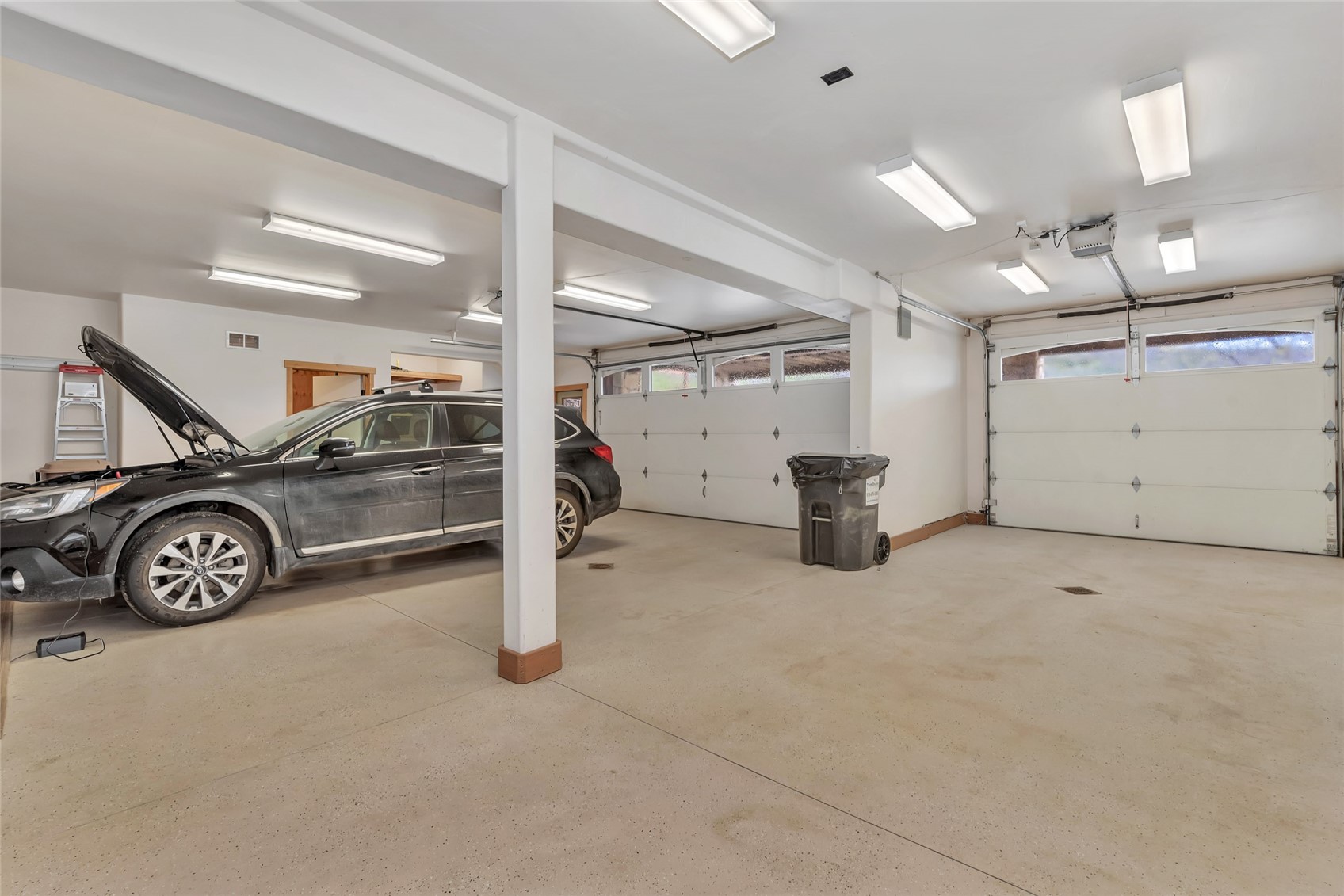 31485 Deerwood Ranch Road Steamboat Springs, CO 80487 - Photo 46 of 49 a view of a garage with a car parked