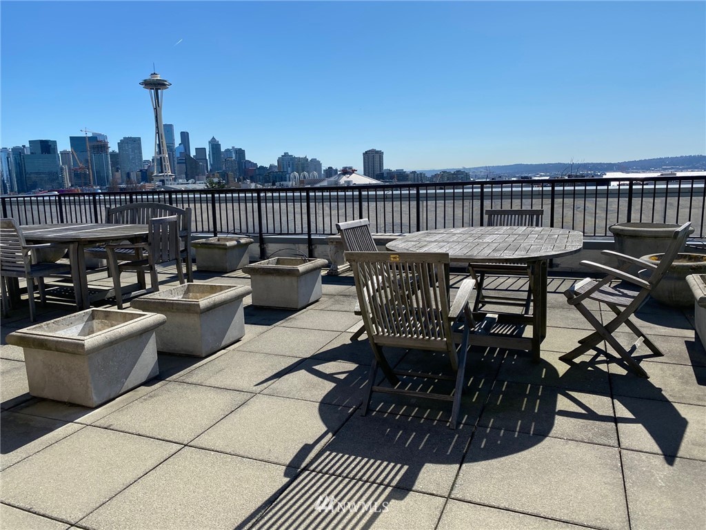 a roof deck with table and chairs