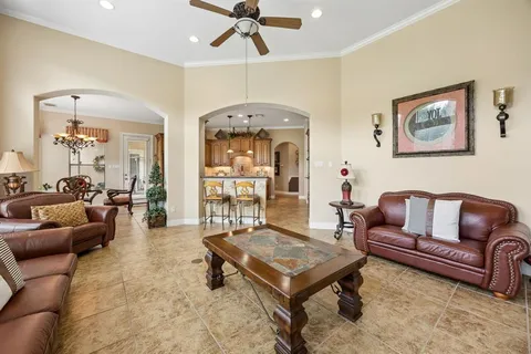 a living room with furniture and a chandelier