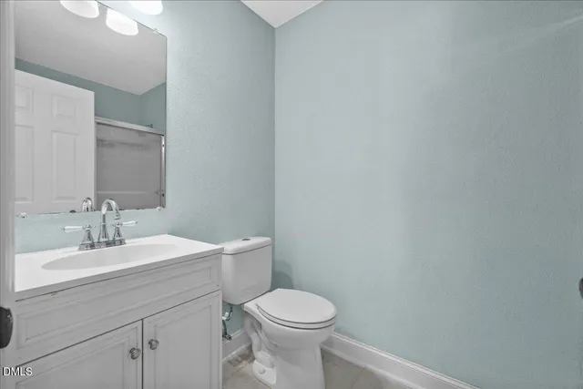 a bathroom with a glass shower door
