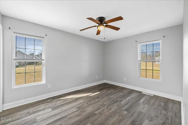 a view of room with hardwood floor and ceiling fan