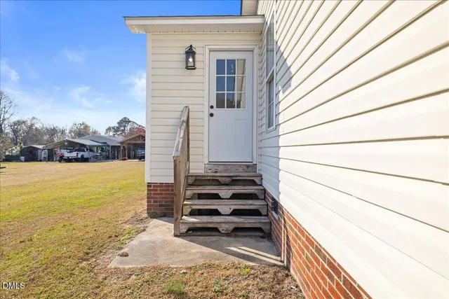 a view of a patio with a table and chairs