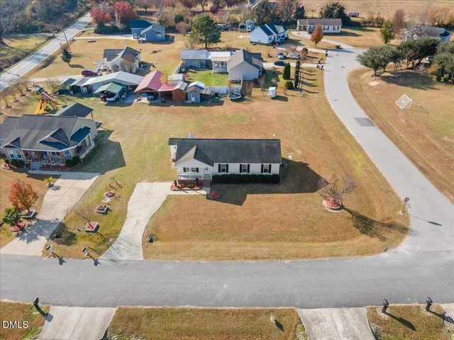 an aerial view of a house with a swimming pool