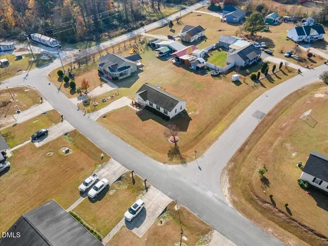 an aerial view of a houses with a swimming pool