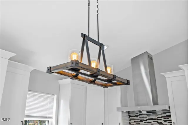 a large kitchen with stainless steel appliances kitchen island granite countertop a refrigerator a stove and a sink with wooden floor