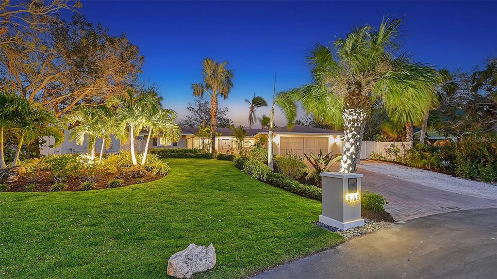 5165 Sandy Cove Avenue Siesta Key, FL 34242 - Photo 1 of 1 a front view of a house with garden