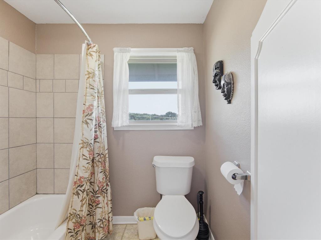 301 Ovilla Road Waxahachie, TX 75167 - Photo 26 of 38 a white toilet sitting next to a bathroom sink