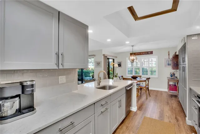 a kitchen with lots of counter top space and wooden floor