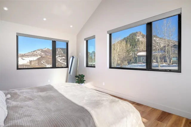 a bedroom with a large bed and a large window