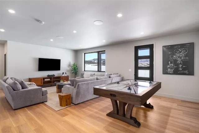 a living room with furniture a flat screen tv and a table
