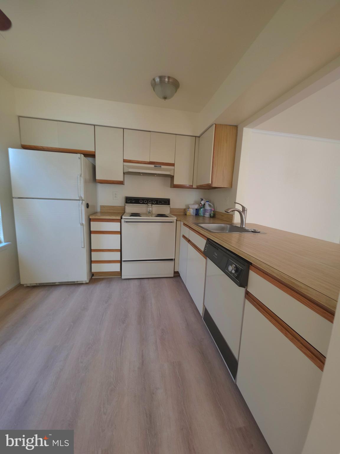 336 A Delancey Place, Unit 336A Mount Laurel, NJ 08054 - Photo 7 of 18 a kitchen with a sink a stove and cabinets