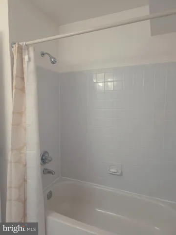 a bathroom with a shower and a bath tub