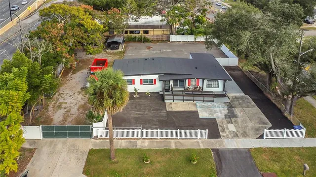 an empty room with windows and fireplace