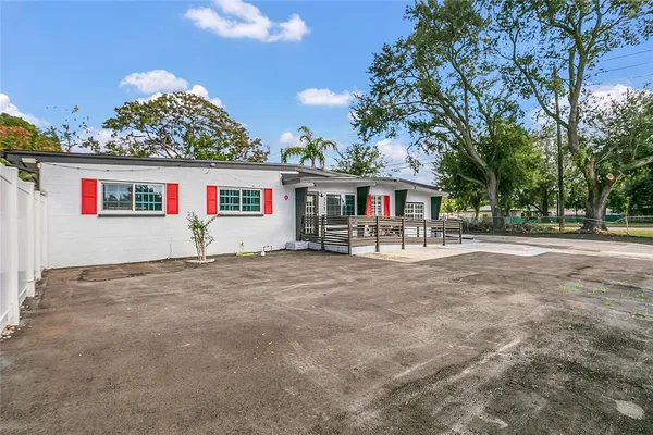 a view of a house with a yard and sitting area