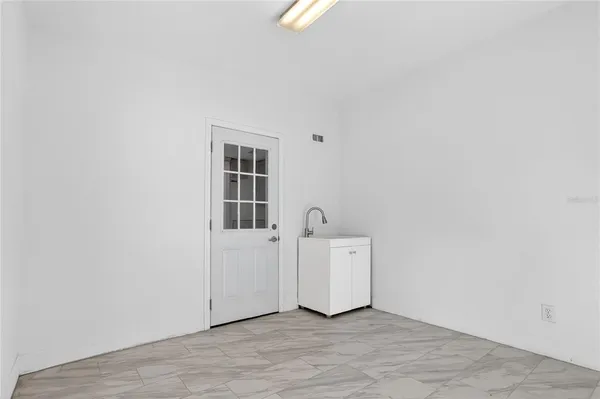 a view of a room with wooden floor and window