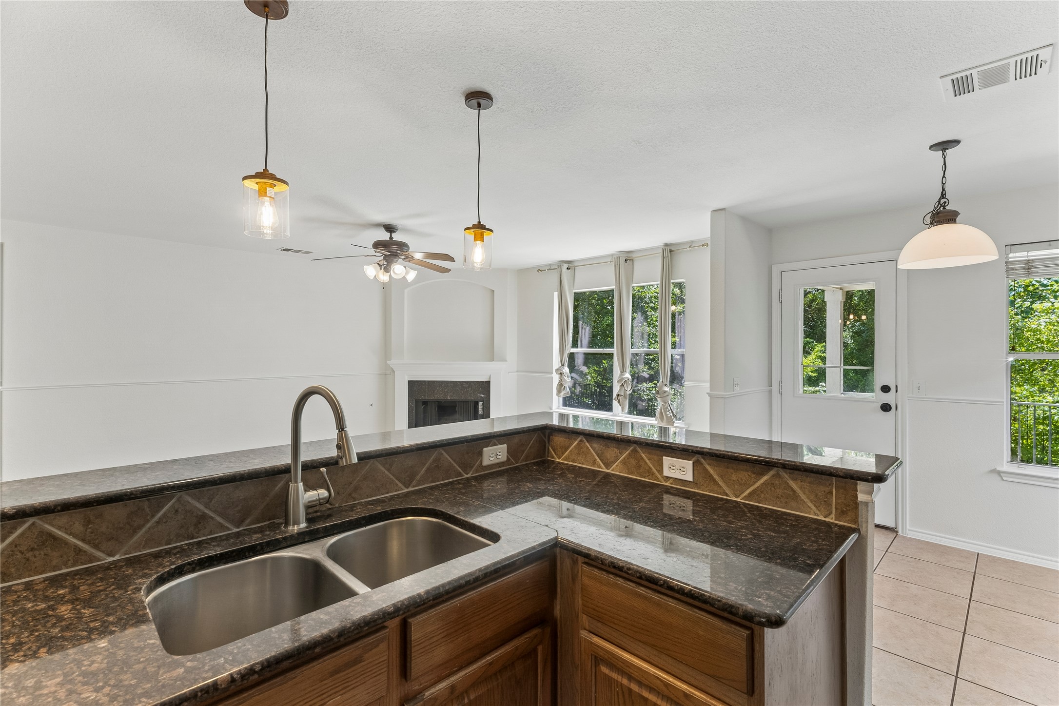 2372 Paradise Ridge Drive Round Rock, TX 78665 - Photo 7 of 40 An inviting kitchen with a granite island overlooks a naturally illuminated living space, perfect for entertaining.
