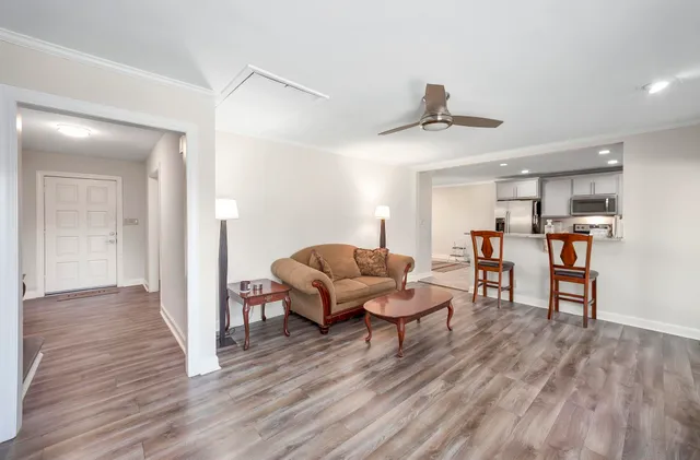 a living room with furniture and a wooden floor