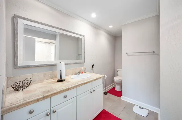a bathroom with a sink vanity mirror and vanity