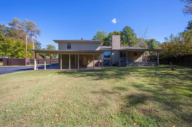 a view of a house with pool and chairs