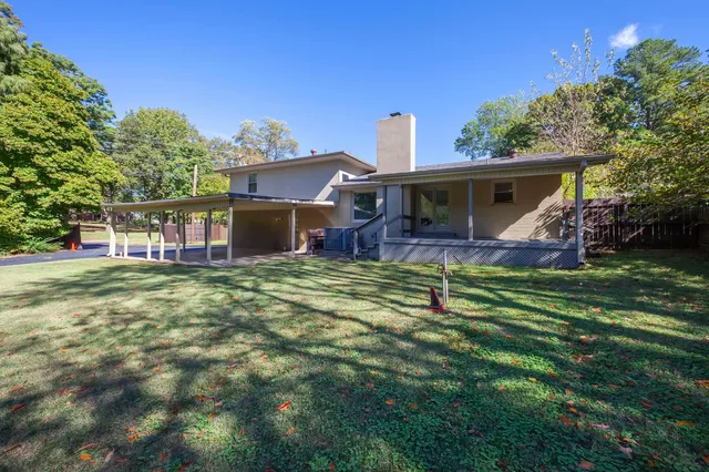 a house that has a tree in front of it