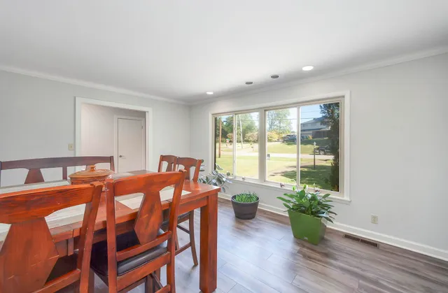 a view of a dining room with furniture and wooden floor